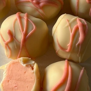 Creamsicle white chocolate truffle in a red tin