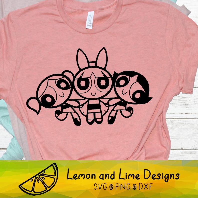 May include: Black and white line art illustration of the Powerpuff Girls, Blossom, Bubbles, and Buttercup, standing together. The image is on a pink t-shirt.