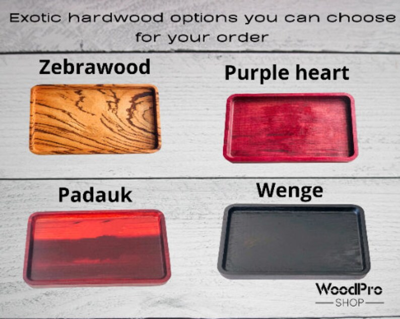 May include: Four wooden trays in different exotic wood types: zebrawood, purple heart, padauk, and wenge. The trays are all rectangular and have a smooth, polished finish.
