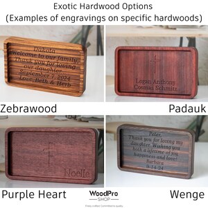 May include: Four rectangular wooden trays with engraved text and designs. The trays are made from zebrawood, padauk, purple heart, and wenge. Each tray features unique text, including names and dates, and a cross design.