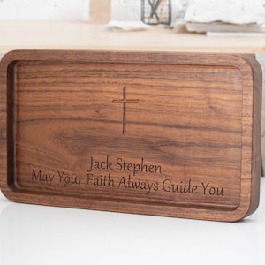 May include: A wooden tray with a cross and the inscription "Jack Stephen. May Your Faith Always Guide You."