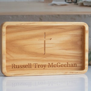 May include: A wooden tray with a cross carved into the top and the name "Russell Troy McGeehan" engraved below.