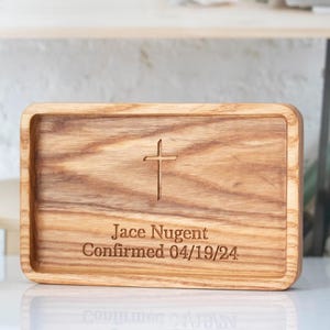 May include: A wooden tray with a cross design and the text "Jace Nugent Confirmed 04/19/24" engraved on it.