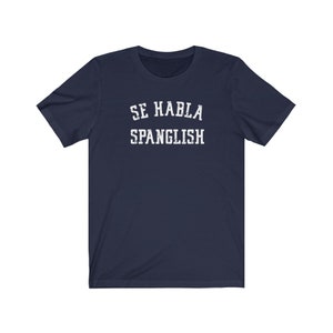 May include: Navy blue t-shirt with white text that reads "Se Habla Spanglish".