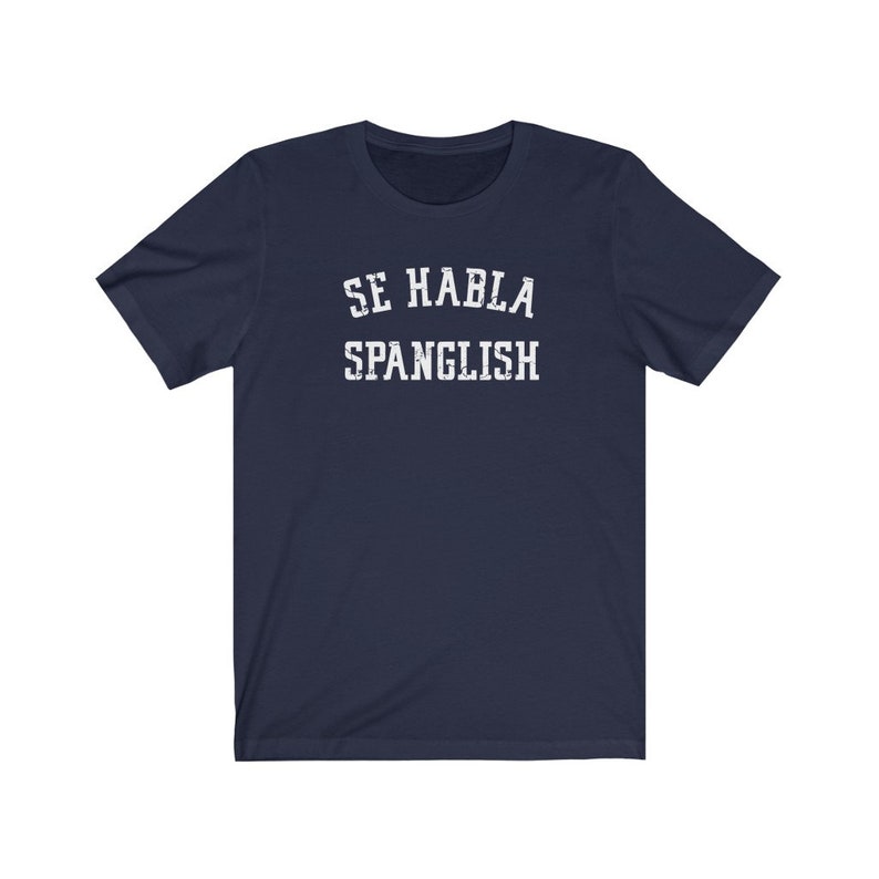 May include: Navy blue t-shirt with white text that reads "Se Habla Spanglish".