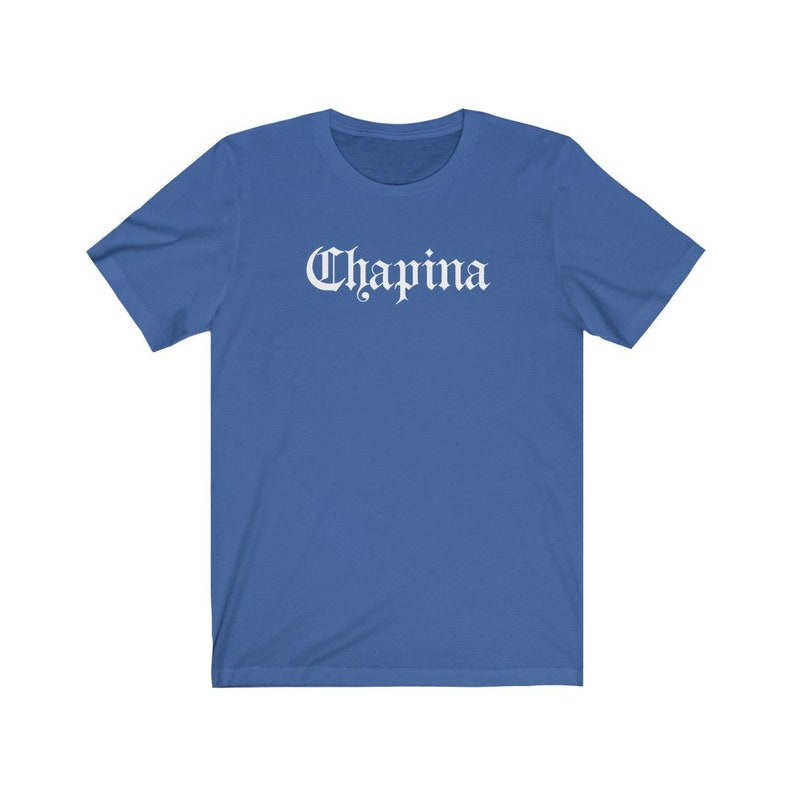 May include: A royal blue t-shirt with a white graphic that says "Chapina" in a gothic font.