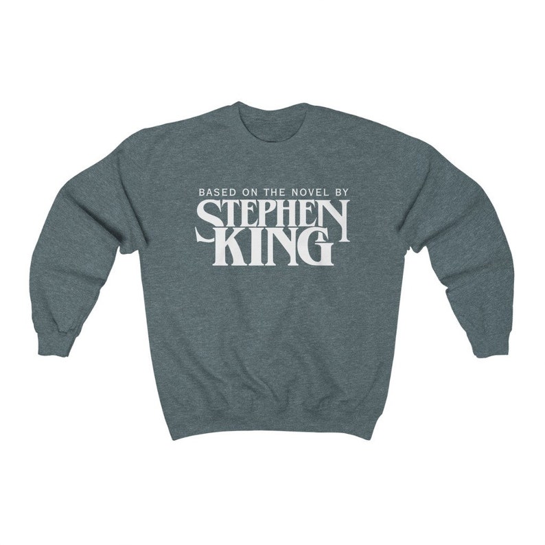 May include: A dark heather gray sweatshirt with the text "Based on the novel by Stephen King" printed in white.