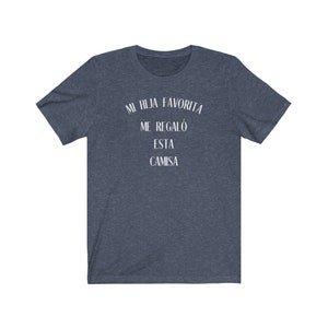 May include: A dark blue t-shirt with white text that reads "Mi hija favorita me regal&oacute; esta camisa".