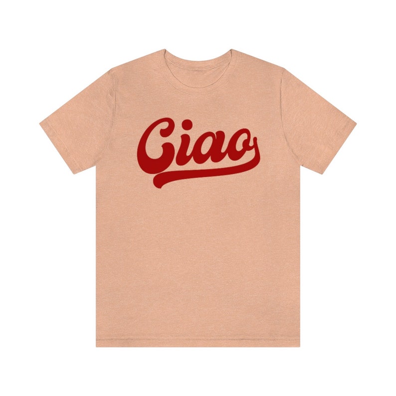 May include: A light peach colored t-shirt with a red stylized word "Ciao" printed on the front.