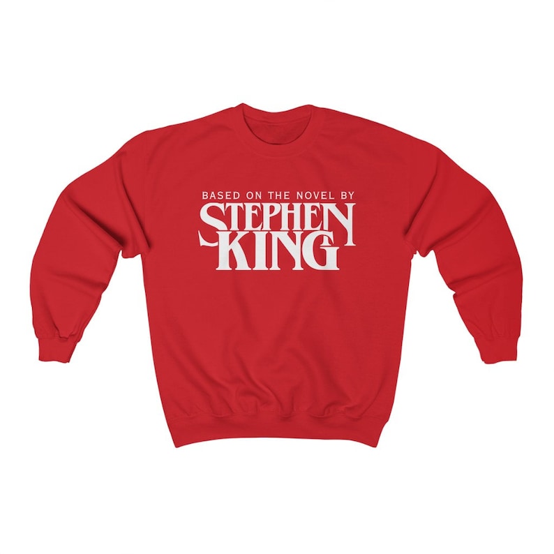 May include: Red sweatshirt with white text that reads "Based on the novel by Stephen King".