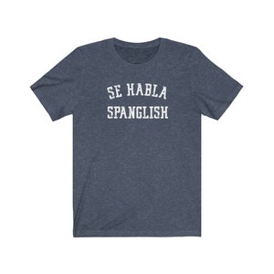 May include: A dark blue t-shirt with white text that reads "Se Habla Spanglish".