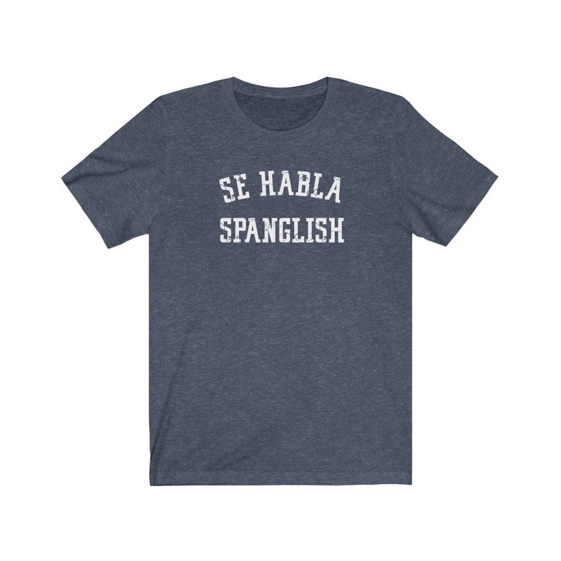 May include: A dark blue t-shirt with white text that reads "Se Habla Spanglish".