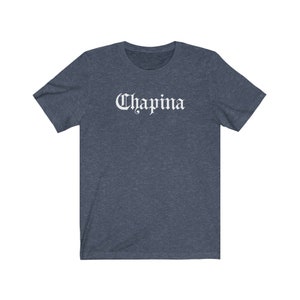 May include: A dark blue t-shirt with the word "Chapina" printed in white on the front.
