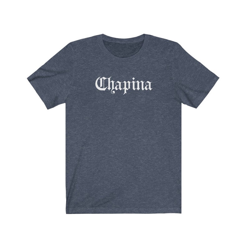 May include: A dark blue t-shirt with the word "Chapina" printed in white on the front.