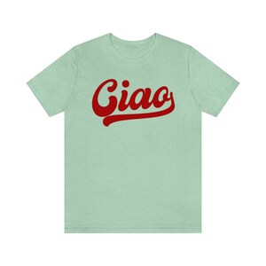 May include: A light green t-shirt with a red retro-style graphic that says "Ciao".