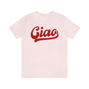 May include: A pink t-shirt with the word "Ciao" in red, stylized lettering.