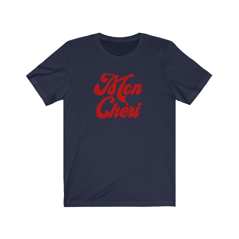 May include: Navy blue t-shirt with a red retro-style graphic that says "Mon Ch&eacute;ri".