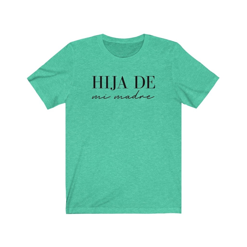 May include: A teal green t-shirt with the text "HIJA DE mi madre" in black.