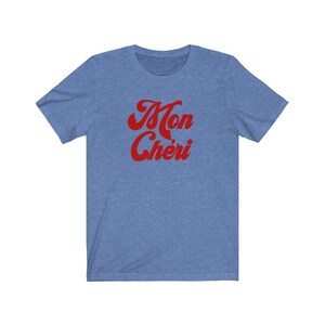 May include: A blue t-shirt with the text "Mon Ch&eacute;ri" in red, retro-style lettering.