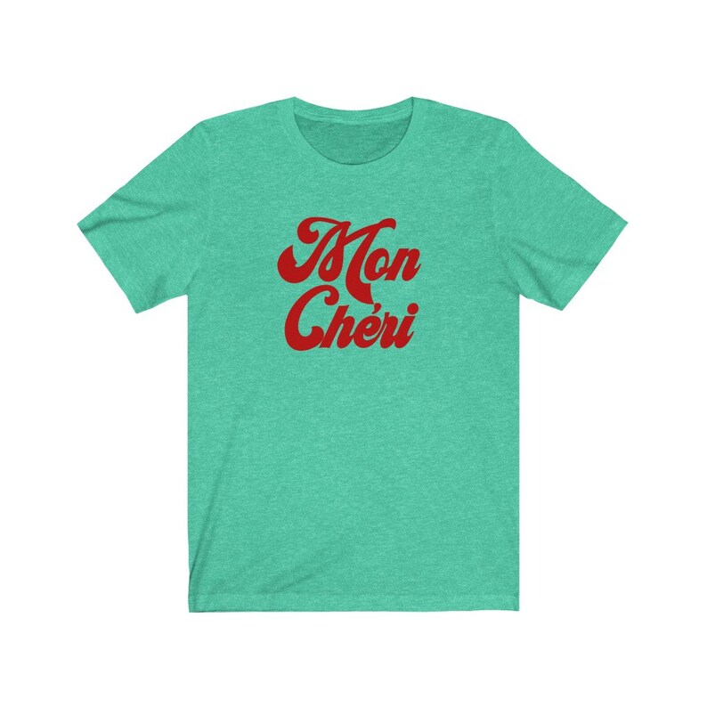 May include: A teal blue t-shirt with the words "Mon Ch&eacute;ri" in red retro font.