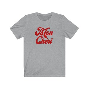 May include: A heather grey t-shirt with a red retro-style graphic that says "Mon Ch&eacute;ri".