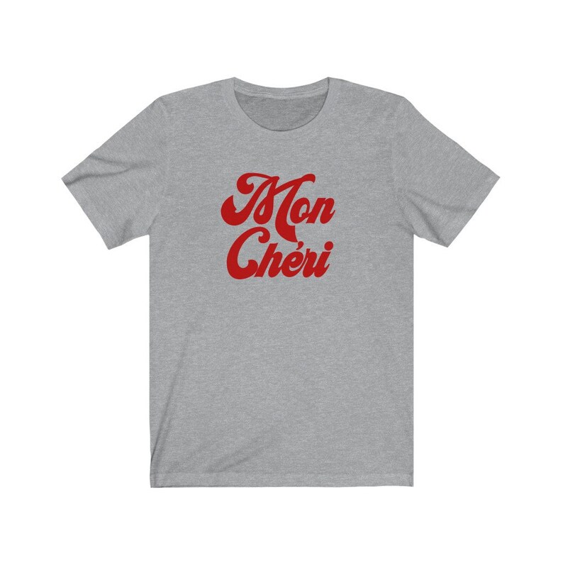 May include: A heather grey t-shirt with a red retro-style graphic that says "Mon Ch&eacute;ri".