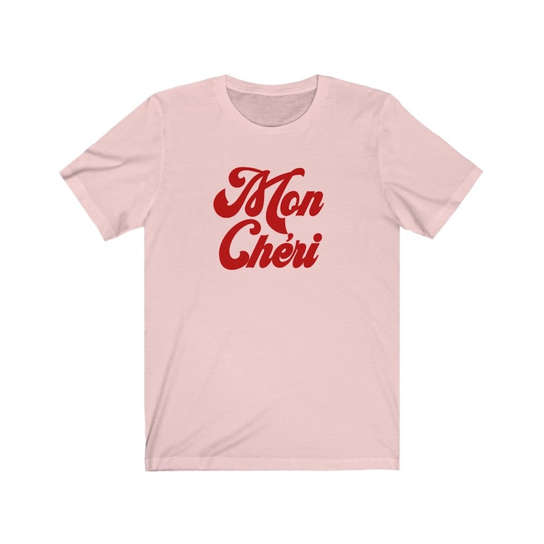 May include: A pink t-shirt with the text "Mon Ch&eacute;ri" in red cursive lettering.
