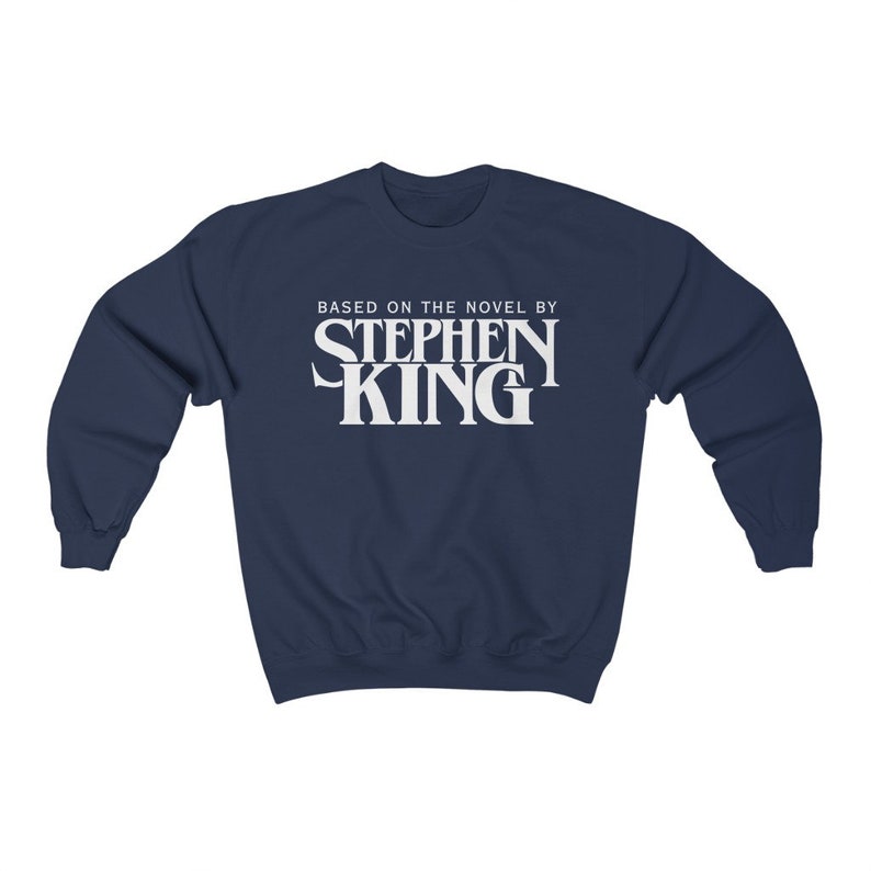 May include: A navy blue sweatshirt with white text that reads "Based on the novel by Stephen King".