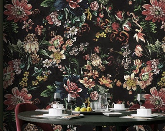 May include: A black dining room with a floral wallpaper featuring a dark background with red, pink, and yellow flowers. A black table with four chairs is set with glasses and plates. The chairs are upholstered in a deep red fabric.