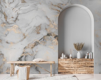May include: A wooden bench with a white blanket in a woven basket sits in front of a wall with a grey and gold marble pattern. A wooden shelf with a vase of dried flowers and other decor sits in an arched doorway.
