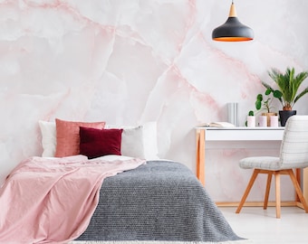 Peut inclure: Une chambre à coucher avec un papier peint en marbre rose, un lit avec une couverture rose et grise et un bureau blanc avec une chaise.