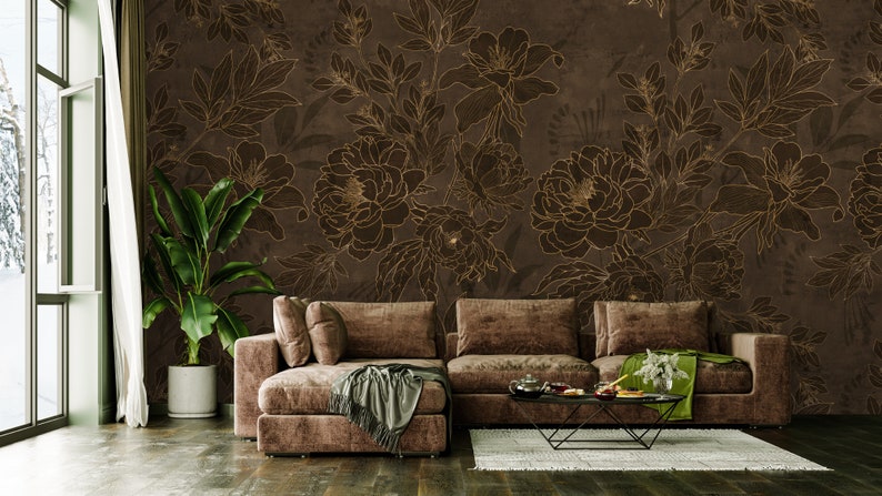 May include: A brown sectional sofa with a throw blanket and pillows in a living room with a brown floral wallpaper featuring gold outlines.