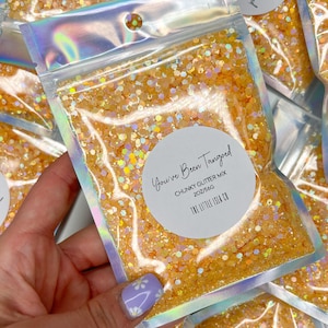 May include: A clear plastic bag filled with chunky orange glitter. The bag has a white label with the text "You've Been Tangoed" and "Chunky Glitter Mix 20Z/56G".