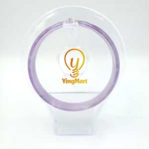 May include: A clear plastic display stand with a purple bangle bracelet. The stand has a light bulb logo with the text "YingMart" on it.