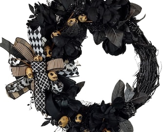 May include: A black and white Halloween wreath with black flowers, black and white checkered ribbon, and gold skull accents.