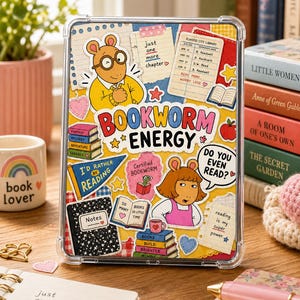 May include: Clear phone case with a colorful collage design featuring cartoon characters, books, and the words "Bookworm Energy." The case includes stickers with phrases like "I'd rather be reading" and "Do you even read?"