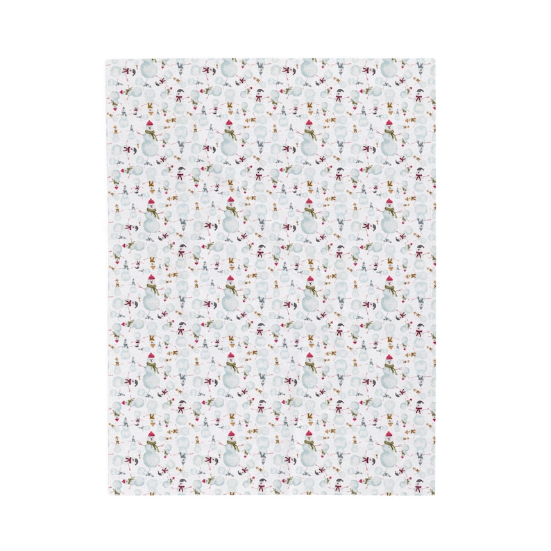 White fabric with a repeating pattern of snowmen. Each snowman has a red hat, green scarf, and twig arms. The background is white with small, scattered snowflakes. A festive, winter-themed design.
