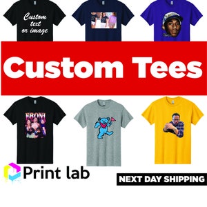 May include: Six different t-shirts with various designs, including a blue t-shirt with a rapper wearing a backwards hat, a gray t-shirt with a blue bear, and a black t-shirt with the text "Custom text or image". The text "Custom Tees" is displayed in large white letters on a red background. The text "Print lab" is displayed in a colorful logo below the t-shirts. The text "NEXT DAY SHIPPING" is displayed in black letters on a white background.