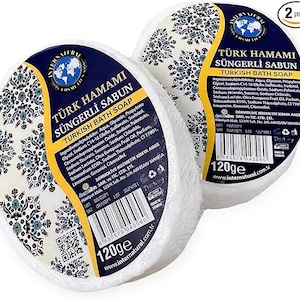 May include: Two white round Turkish bath soaps with a blue and white patterned design. The soap is labelled "Turk Hamami Sungerli Sabun Turkish Bath Soap" and "120ge".