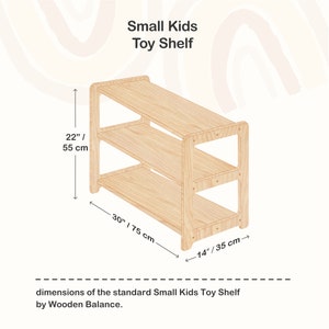 May include: A wooden toy shelf with three shelves, measuring 30 inches wide, 22 inches tall, and 14 inches deep. The shelf is made of natural wood and has a simple, modern design.