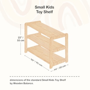 May include: A wooden toy shelf with three shelves, measuring 30 inches wide, 22 inches tall, and 14 inches deep. The shelf is made of natural wood and has a simple, modern design.