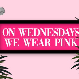 May include: A pink sign with black trim and the text "ON WEDNESDAYS WE WEAR PINK" in white letters.