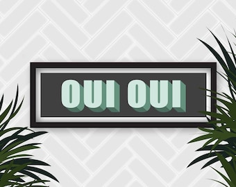 May include: A black framed sign with a white background and the text "OUI OUI" in green letters with a shadow effect. The sign is hanging on a white wall with a herringbone pattern.