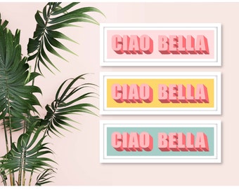 May include: Three framed prints with the text "Ciao Bella" in pink letters with a 3D effect. The frames are white and the backgrounds are pink, yellow, and light blue.