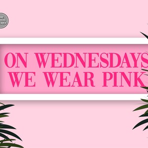 May include: A pink background with a white frame around the text "On Wednesdays We Wear Pink" in pink letters.  The text is surrounded by green palm leaves.