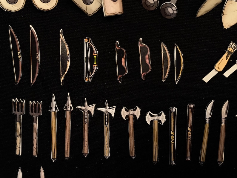May include: An assortment of illustrated miniature weapons, including bows, axes, spears, and knives, are arranged on a black background. The weapons vary in design, with some featuring intricate details and contrasting colors.