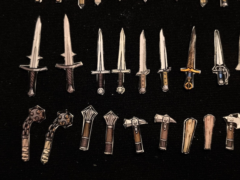 May include: An assortment of hand-drawn fantasy weapons, including swords, daggers, maces, and hammers. The blades and handles vary in design, with a mix of silver, brown, and gold accents. The weapons are arranged on a black background.
