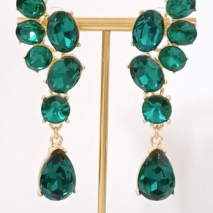 Oscar de la Renta- Earrings encrusted with green crystals.