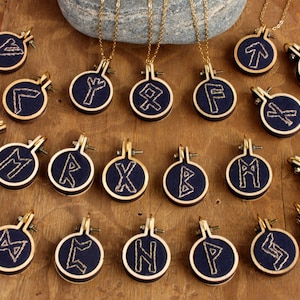 Pendants with runes hand embroidered