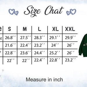 May include: Size chart for a sweatshirt with measurements in inches for sizes S, M, L, XL, and XXL. The chart shows the length, chest, shoulder width, and sleeve length for each size.